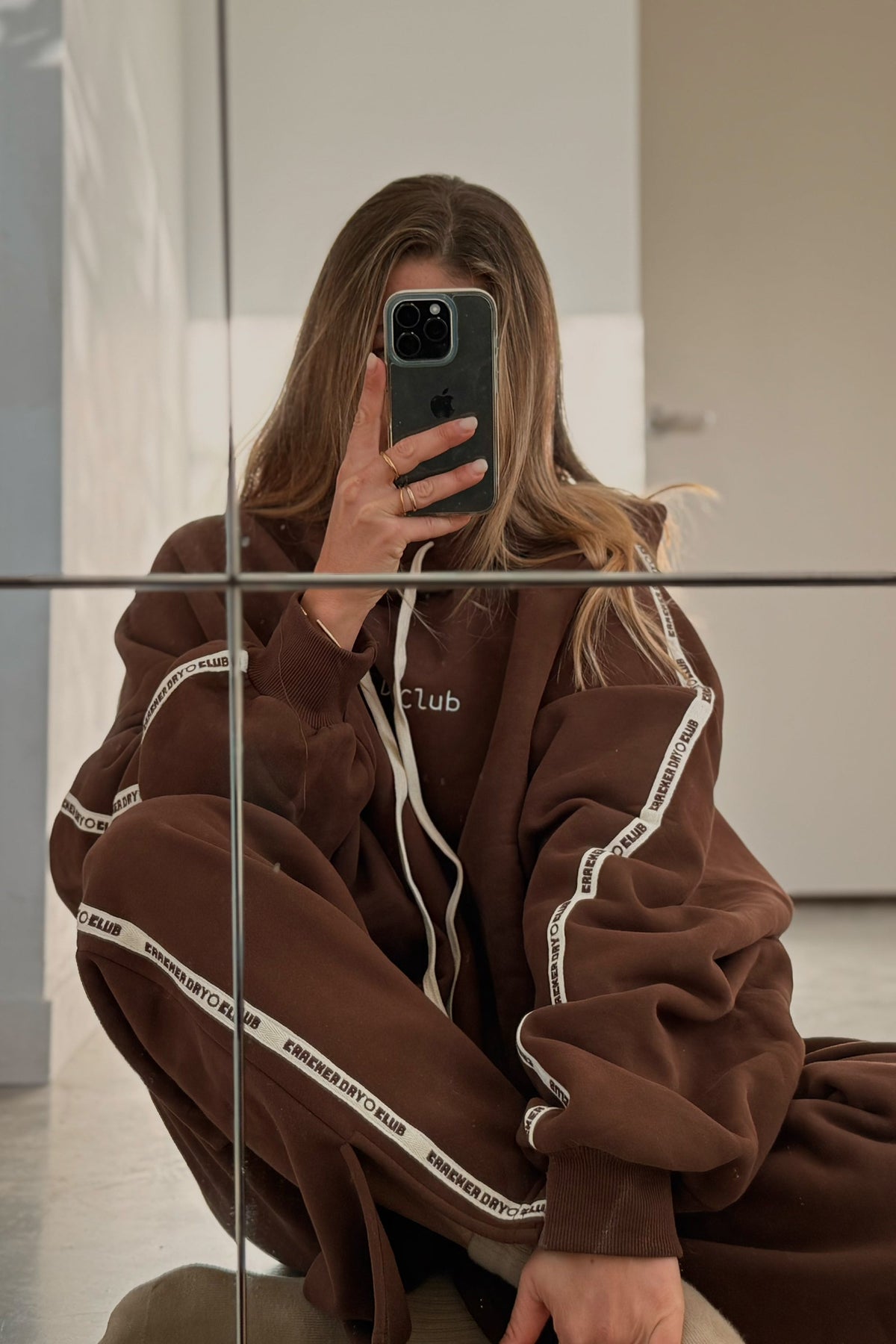 cloud racer hoodie in chocolate colour by cracker day club worn with matching sweatpants with featured embroidery