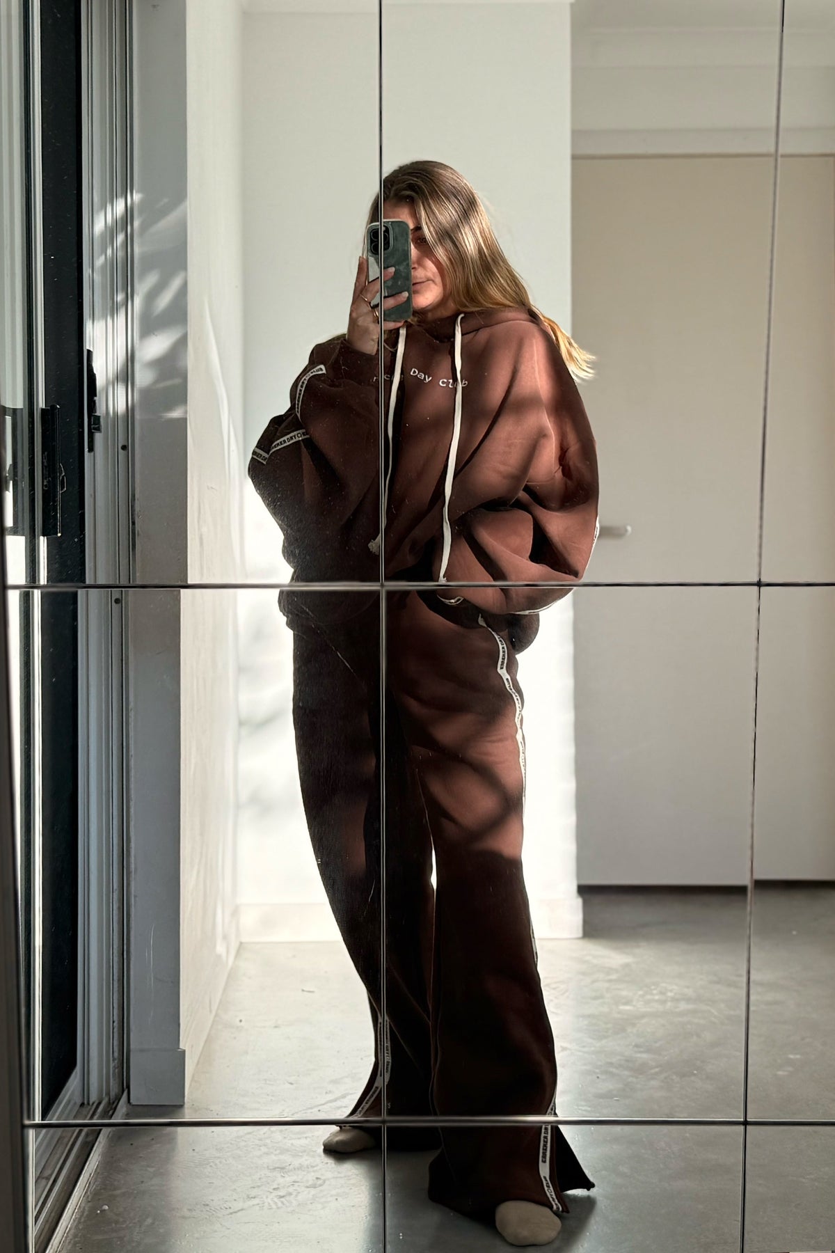 full length photo of cloud racer hoodie in chocolate colour by cracker day club worn with matching sweatpants