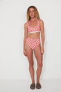 Woman wearing a red and white checkered bikini set on a white background