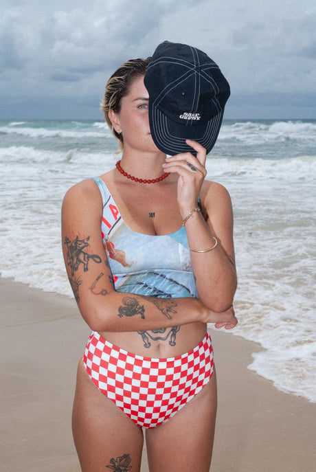 Woman wearing a red and white checkered bikini set at a beach