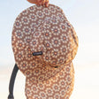 Kids Coco Boardsox surf hat in cream with a brown daisy print